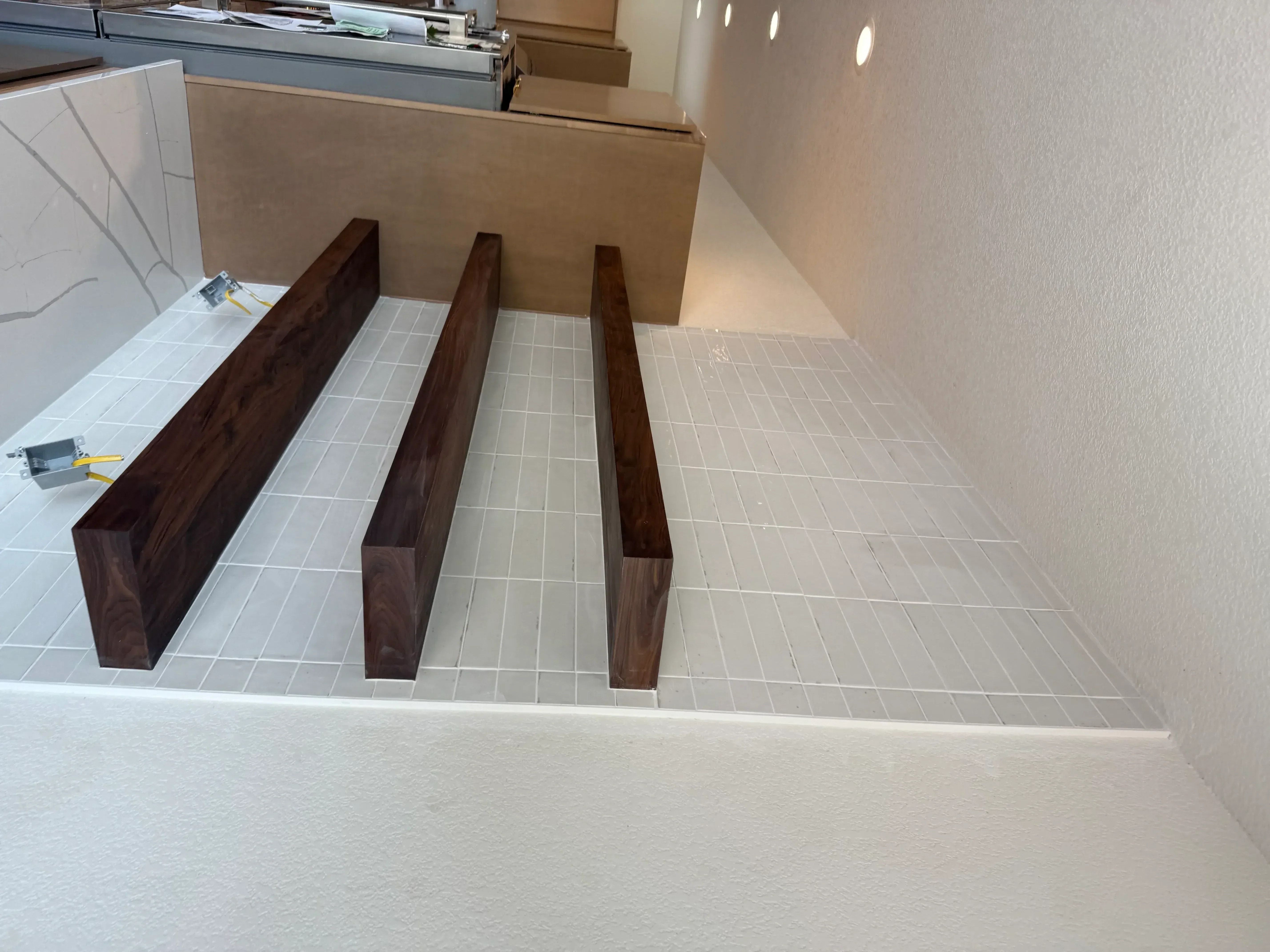 Coffered ceiling with white tiles and three dark wood beams installed in kitchen space