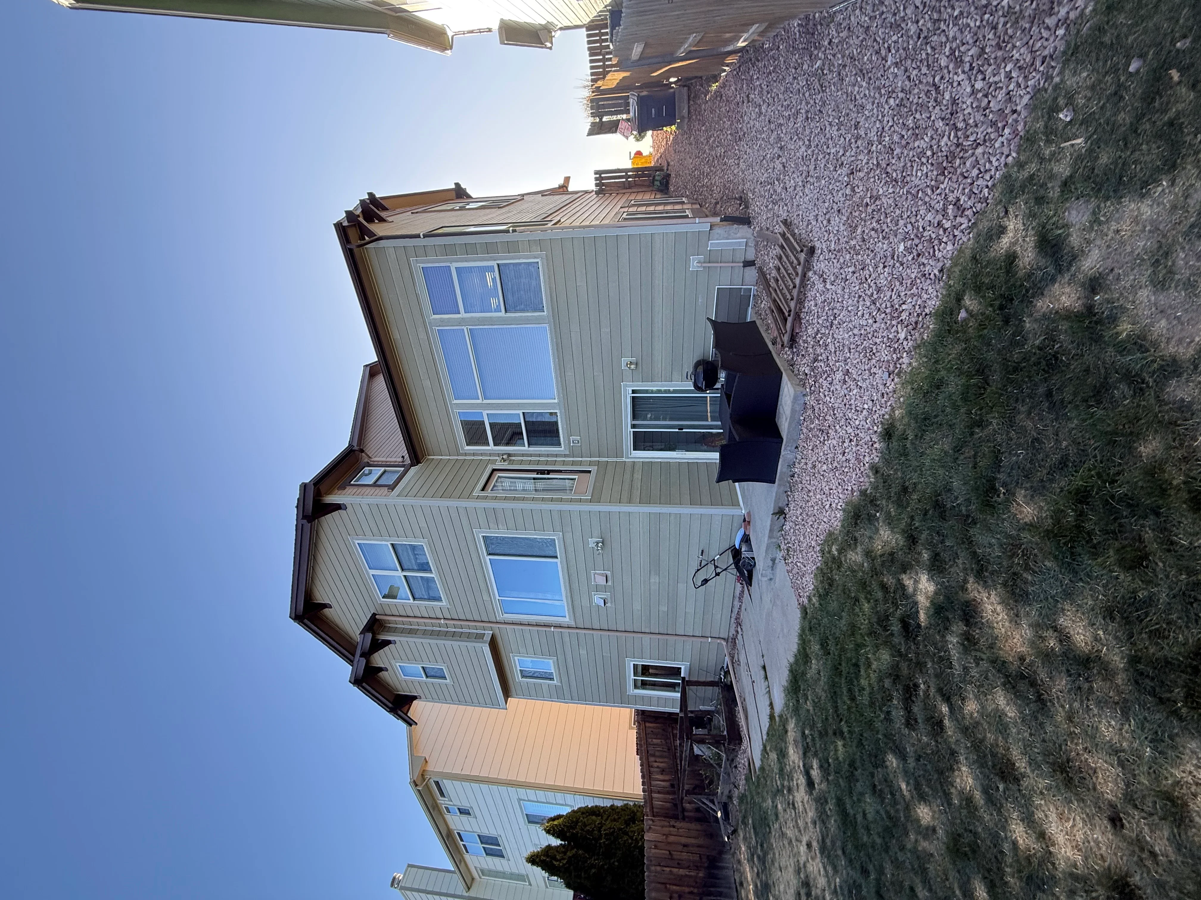 Standing seam metal roof and vertical metal siding on residential home exterior
