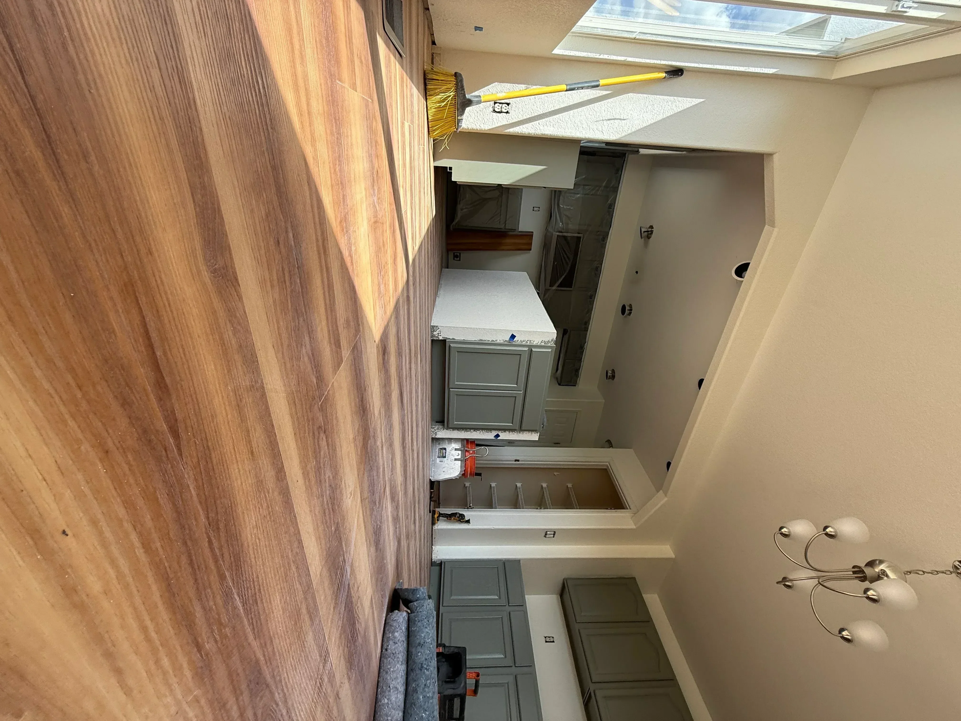 Kitchen remodel with gray-green painted cabinets, hardwood flooring, and recessed lighting