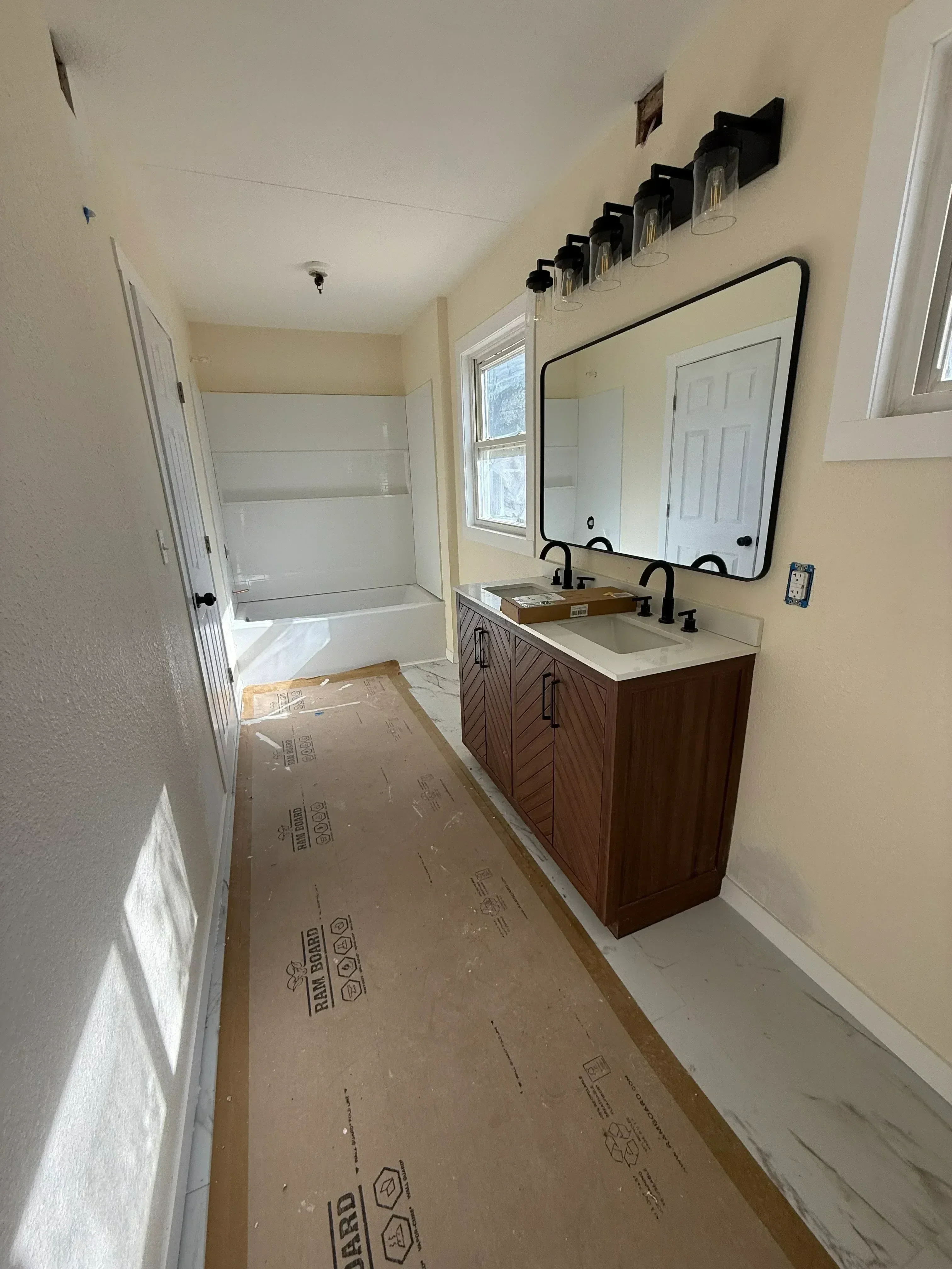 Kitchen remodel with new wood cabinetry, electrical wiring, and drywall preparation