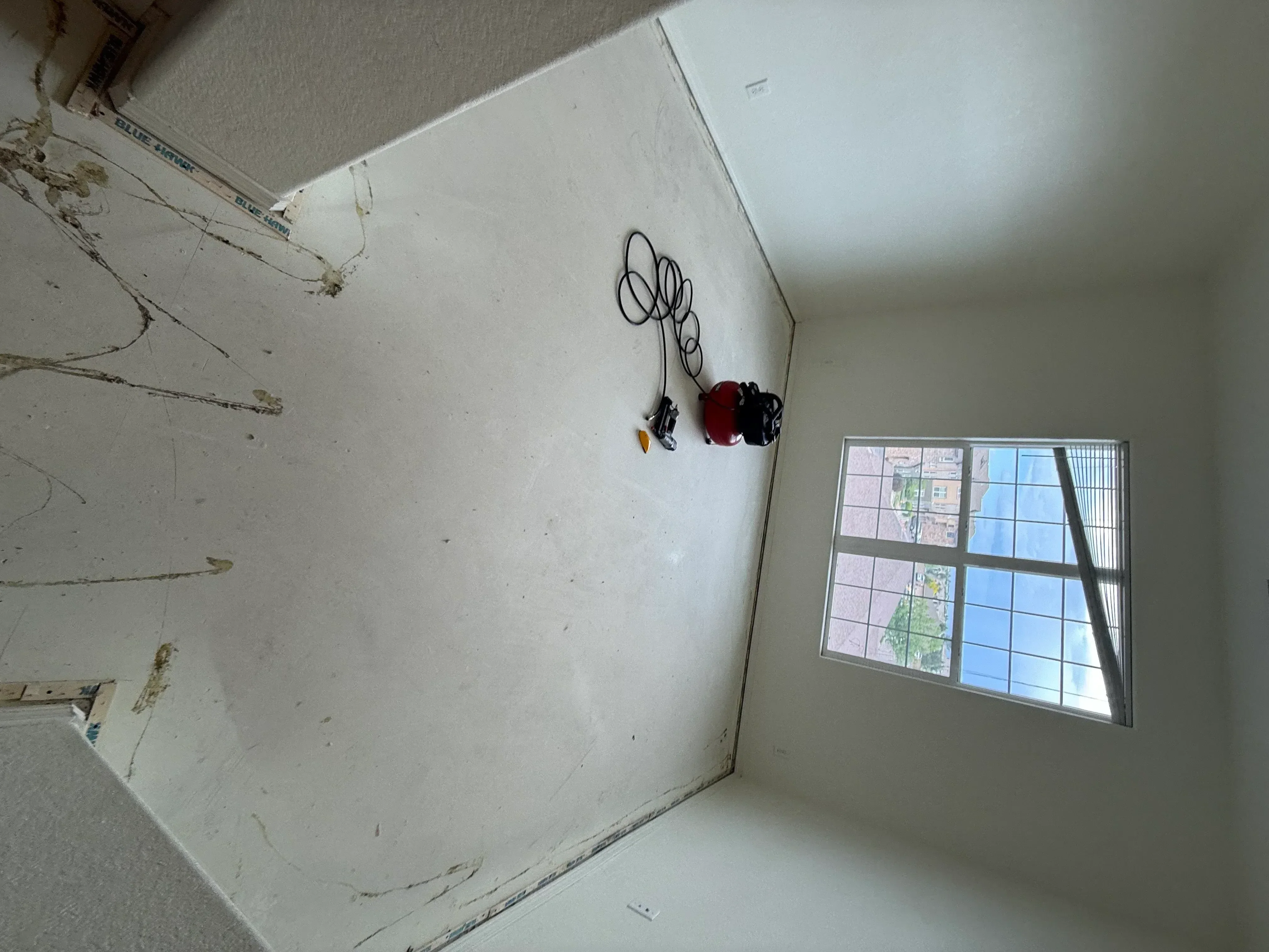 Drywall installation with joint compound finishing, metal window frame, and electrical rough-in