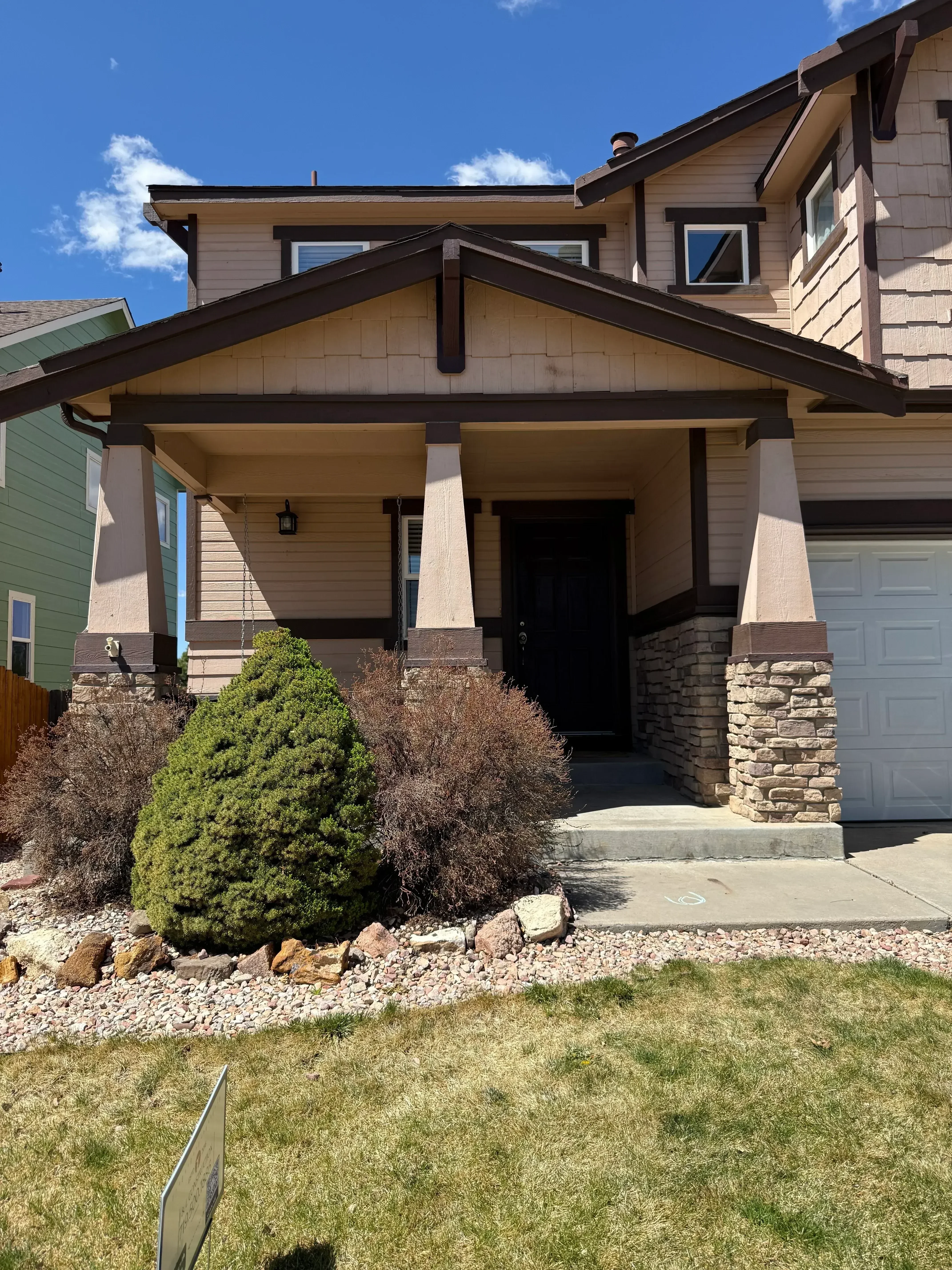 Multi-level composite deck with dark framing, metal railings, and new exterior siding