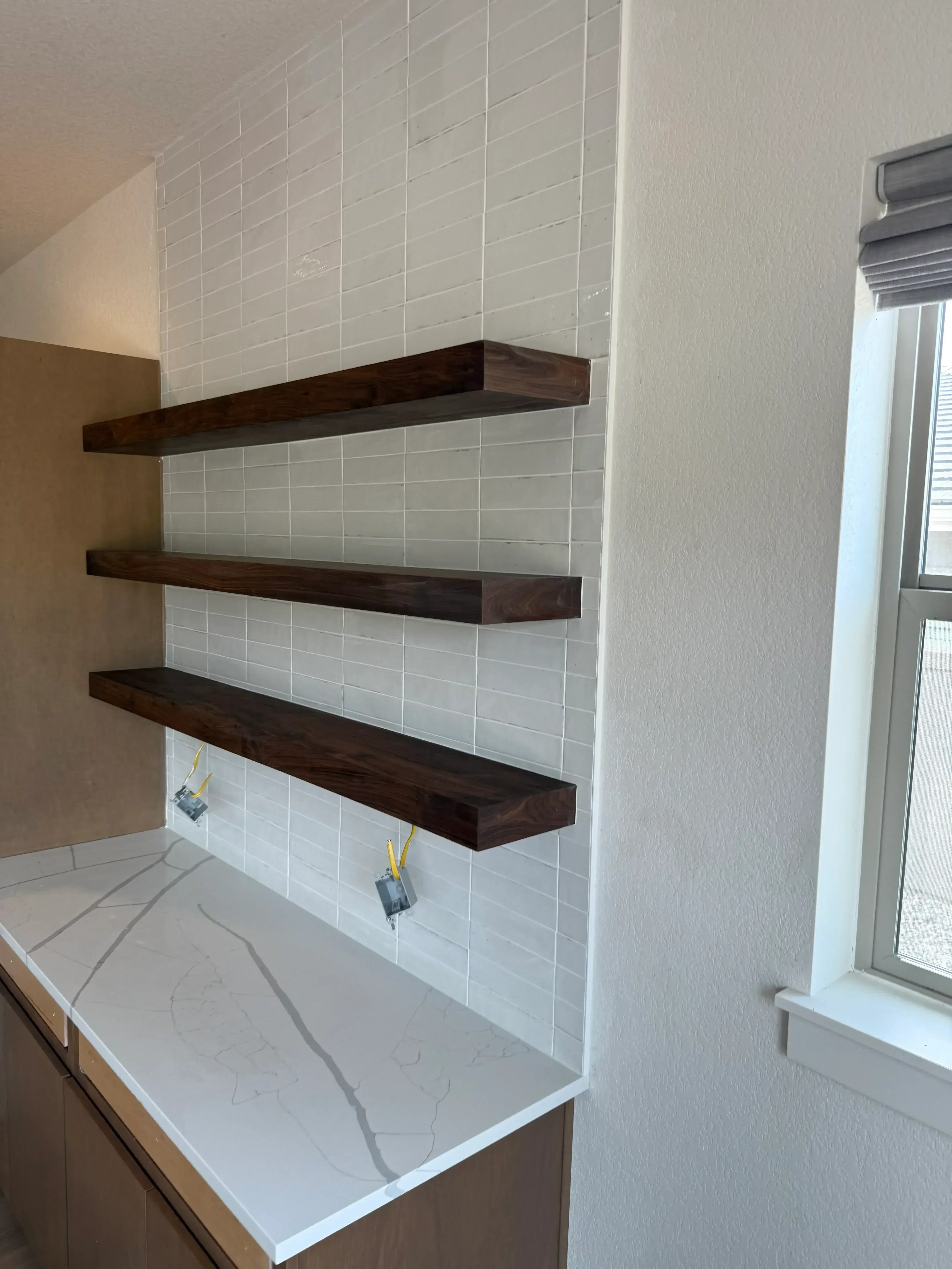 White shiplap ceiling with three dark wood beams and recessed lighting installation