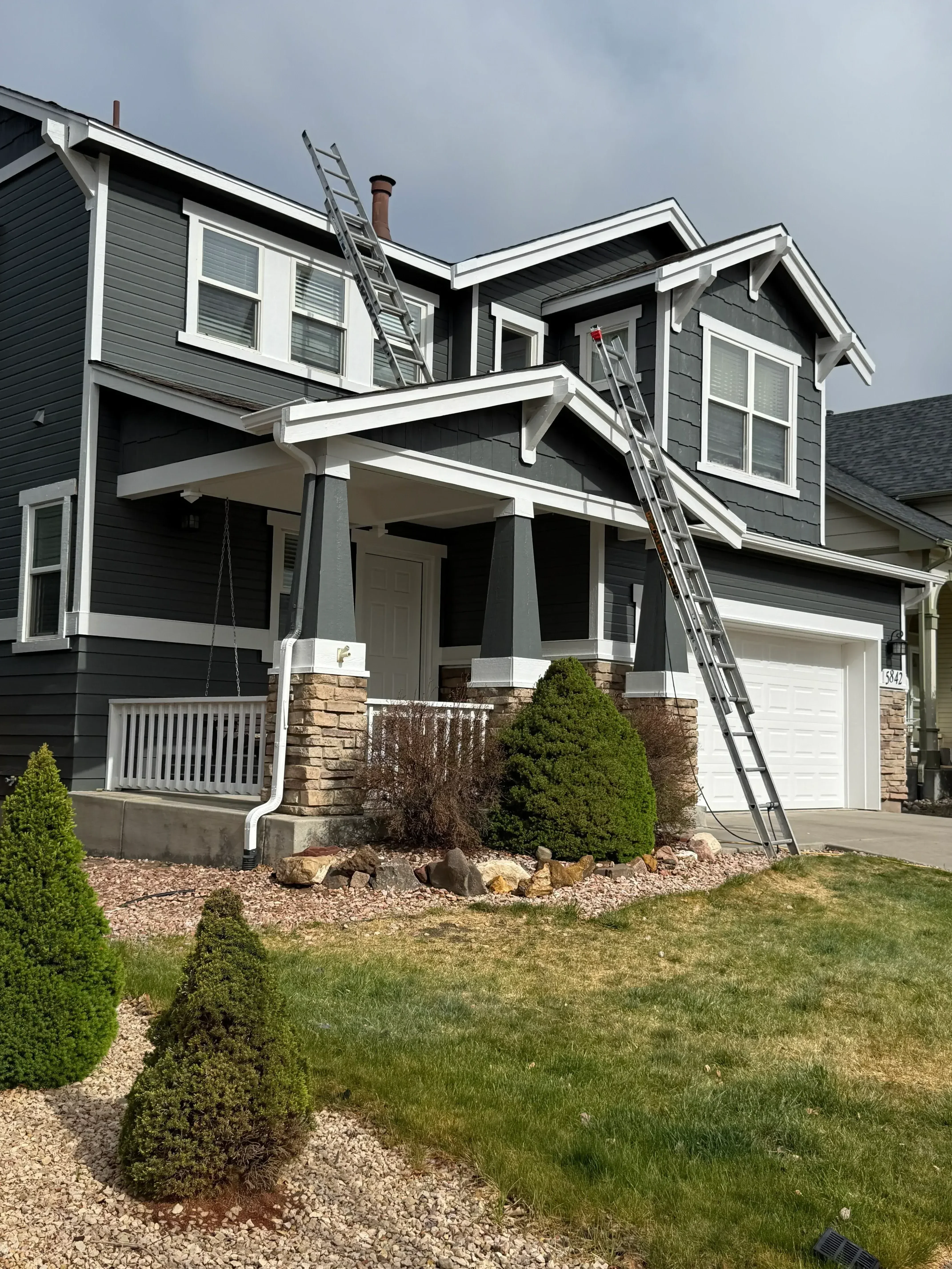 Modern kitchen renovation with updated cabinetry and new exterior siding and railings